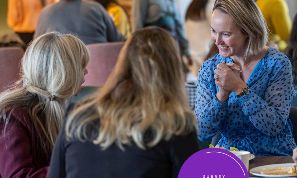 Women entrepreneurs excitedly talking at a table over lunch