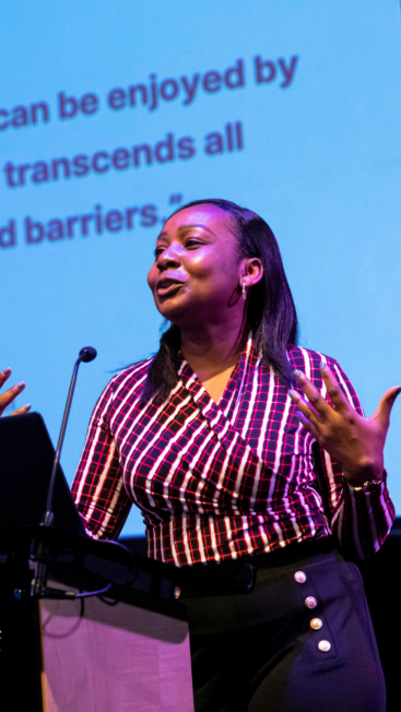 A woman presenting behind a lectern